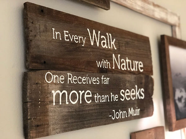 Eco-friendly wood sign with personalized John Muir quote and vintage-inspired design on reclaimed wood planks by Urban Garden Studio