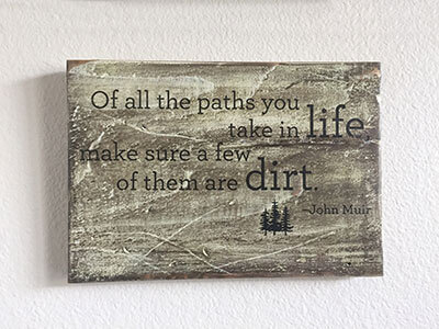 - Handcrafted rustic wood sign with a custom John Muir quote for a natural, outdoorsy touch by Urban Garden Studio