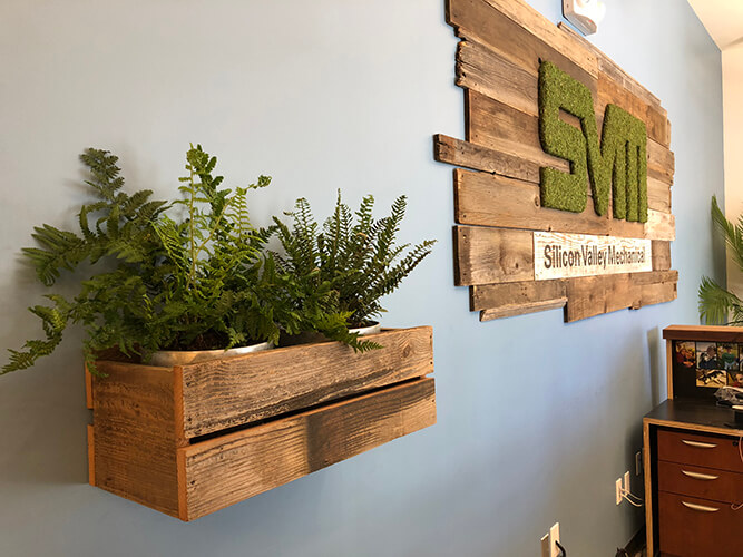 Custom reclaimed wood wall planters handmade from rustic barn wood and planted with palm trees completing this patio design by Urban Garden Studio Unique handcrafted distressed wall planters made from rustic barn wood comes in custom sizes for home or business.