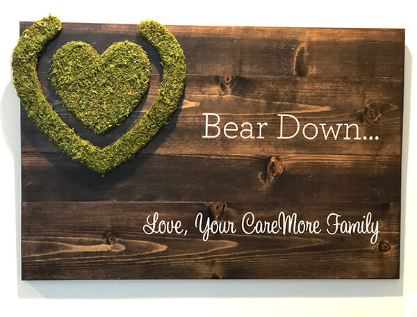 Elevate your company's branding with a custom sign made from reclaimed wood and adorned with a stunning moss-covered logo, providing an eco-friendly and visually striking representation of your brand