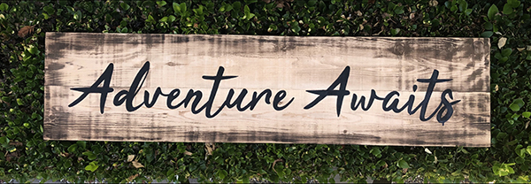 Adventure Awaits! Custom hand painted barn wood Signage for a company swag store by Urban Garden Unique hand-painted barn wood signage for a company swag store with custom branding and design by Urban Garden Studio