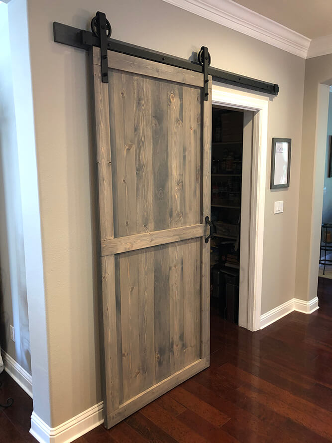 Handcrafted rustic sliding barn door by Urban Garden Studio, made from reclaimed wood for a unique and stylish addition to your home decor by Urban Garden Studio