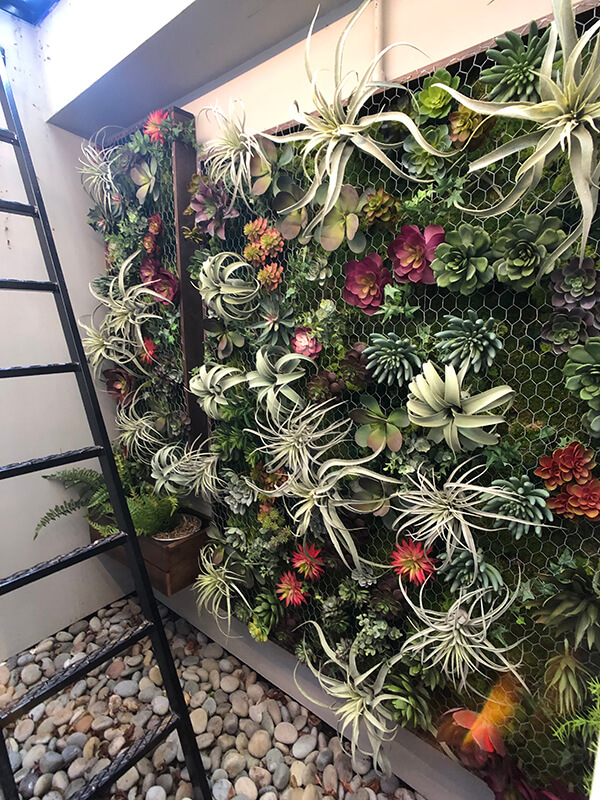 Beautiful succulent wall garden filled with faux succulents, air plants, preserved moss and framed out in rustic wood. Creating a vertical succulent garden.