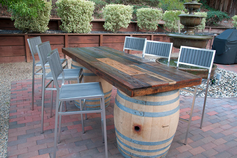 Reclaimed wood wine table by Urban Garden Studio Elevate your wine-tasting experience with a reclaimed wood wine table by Urban Garden Studio, expertly crafted from eco-friendly materials for a unique and sustainable addition to your home decor.