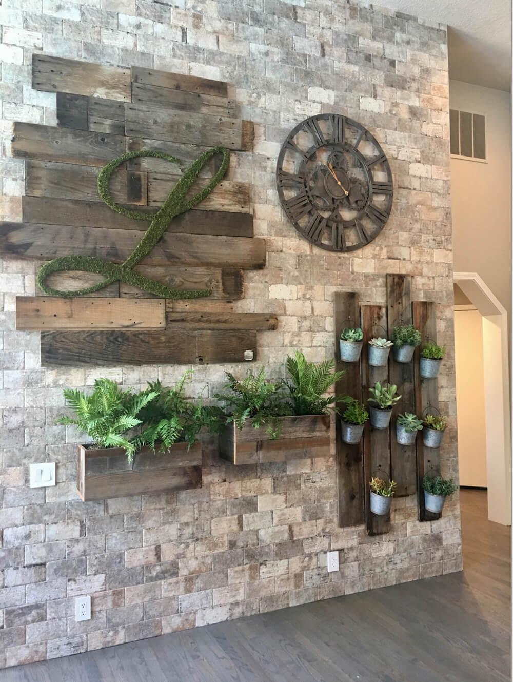 Custom vertical wall garden incorporating rustic wood and a custom moss logo. Custom Rustic planters and rustic decor.