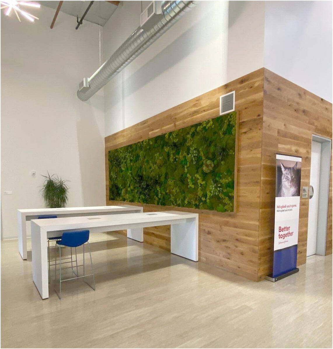 Large preserved living wall for office space. Created with preserved moss and faux plants. Framed with rustic wood.