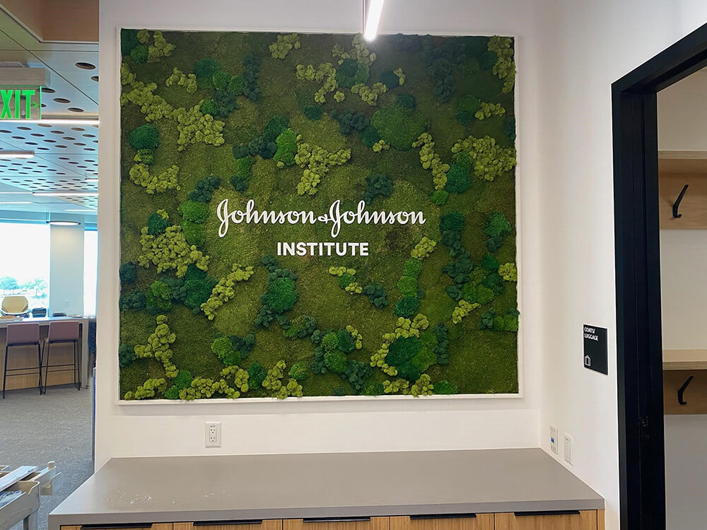 Corporate signage branding created with custom moss signage using a preserved moss wall and white corporate logo by Urban Garden Studio.