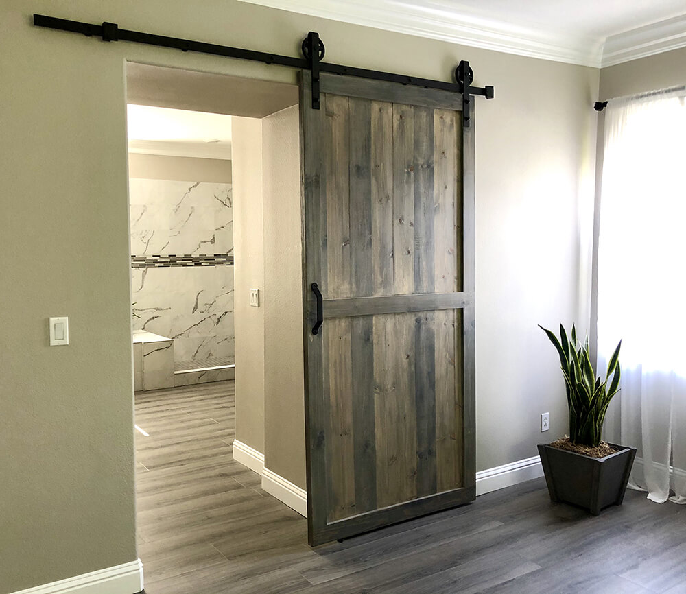 Handcrafted rustic sliding barn door by Urban Garden Studio, made from reclaimed wood for a unique and stylish addition to your home decor by Urban Garden Studio.