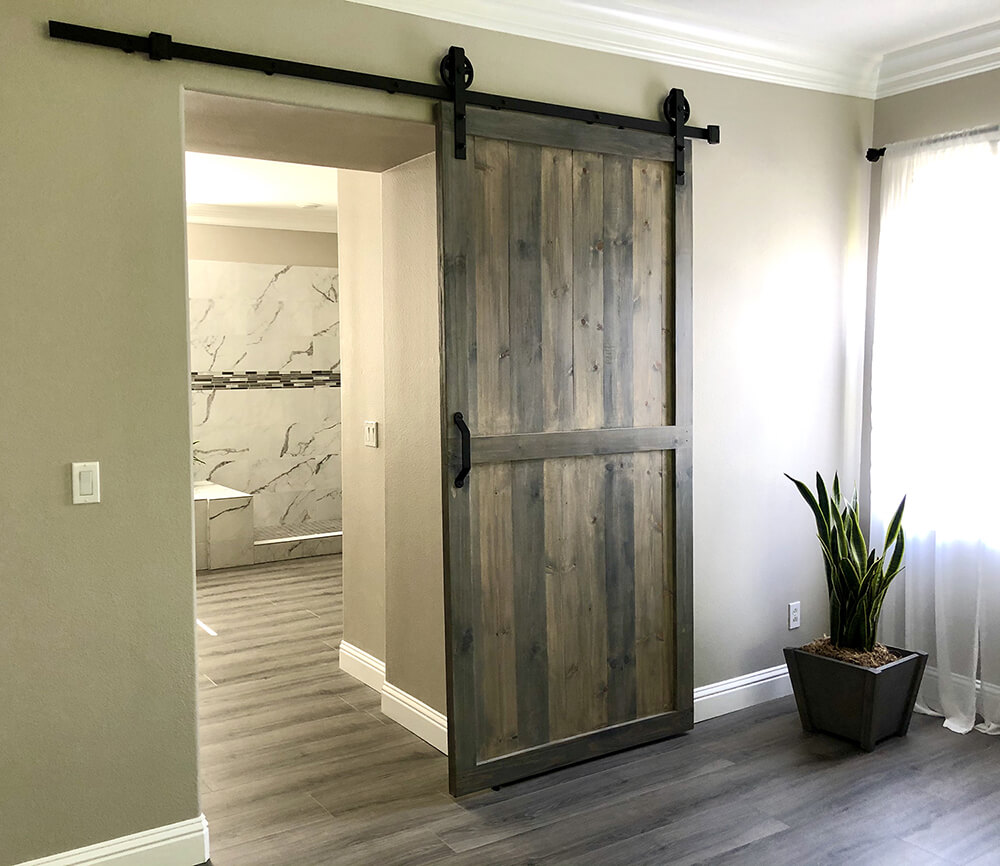 Custom barn wood furniture featuring a sliding barn door by Urban Garden Studio Handcrafted rustic sliding barn door by Urban Garden Studio, made from reclaimed wood for a unique and stylish addition to your home decor by Urban Garden Studio.