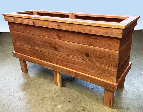 Custom redwood raised planter box makes a perfect vegetable planter. Custom made in any size.