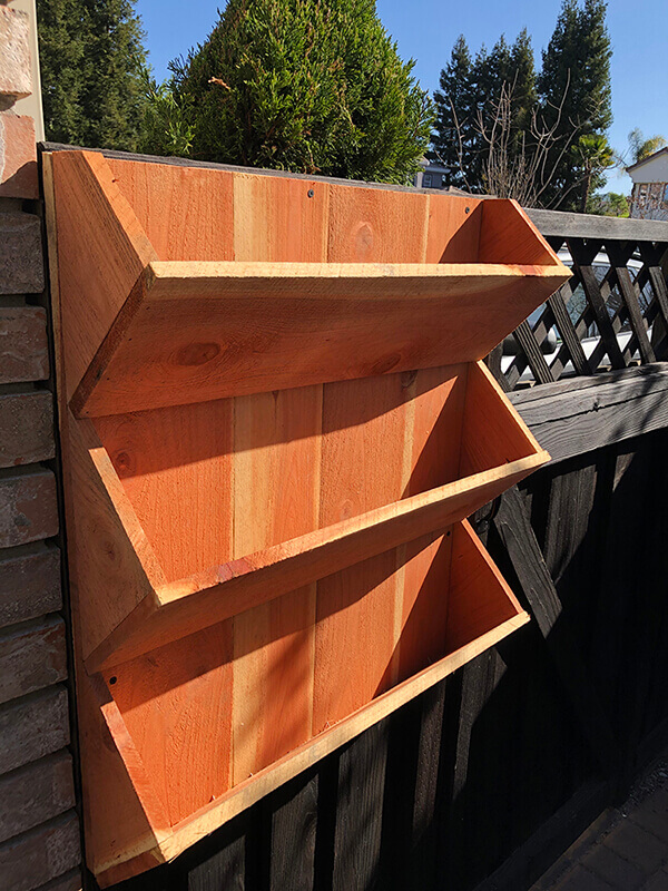 Vertical wall redwood planter perfect to plant outdoor vegetables like straw berries by Urban Garden Studio.