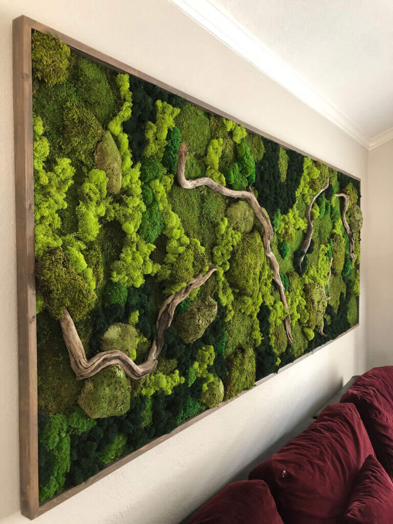 This beautiful framed moss art is a stunning living wall art piece, incorporating various types of moss such as cushion moss, pool moss, and reindeer moss, woven together with driftwood. The result is a gorgeous and sustainable piece of indoor greenery that adds natural beauty and biophilic design to any space by Urban Garden Studio.