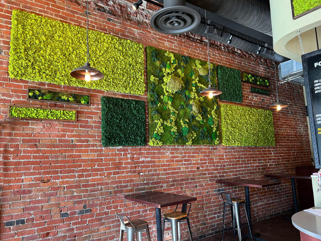 Preserved moss wall art utilizing a dynamic grid created with moss wall panels comprised of a variety of preserved moss by Urban Garden Studio.