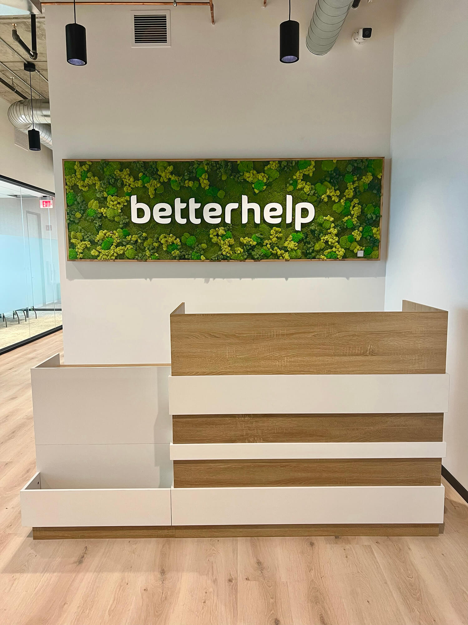 Corporate signage branding created with custom moss signage using a preserved moss wall and white corporate logo by Urban Garden Studio.